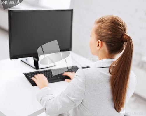 Image of businesswoman with computer in office