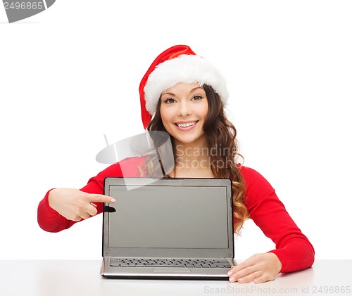 Image of woman in santa helper hat with laptop computer