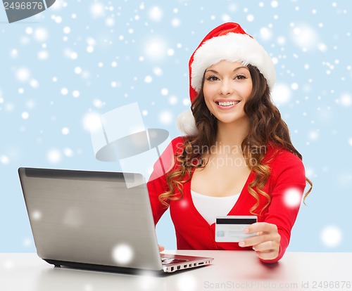 Image of santa helper woman with laptop and credit card