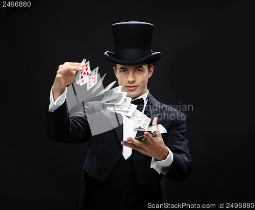 Image of magician showing trick with playing cards