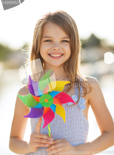Image of happy girl with colorful pinwheel toy