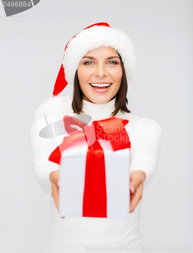 Image of smiling woman in santa helper hat with gift box