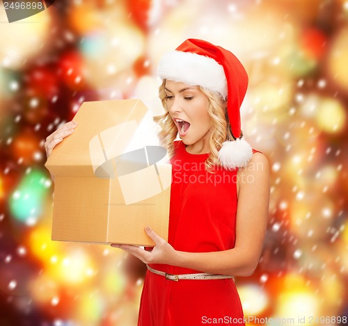 Image of smiling woman in santa helper hat with gift box