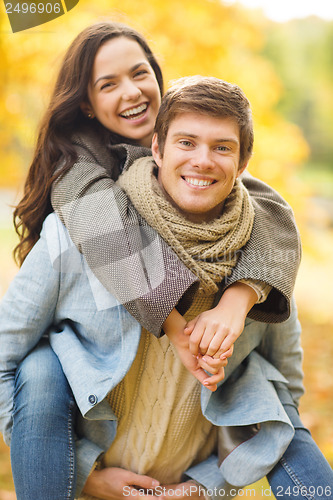 Image of romantic couple playing in the autumn park
