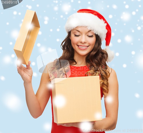 Image of smiling woman in santa helper hat with gift box