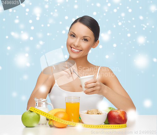 Image of woman with healthy breakfast and measuring tape