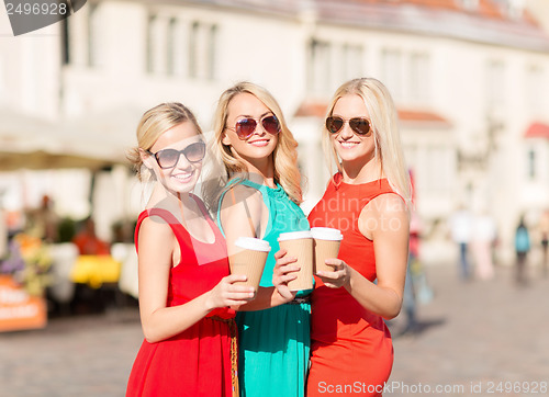 Image of women with takeaway coffee cups in the city