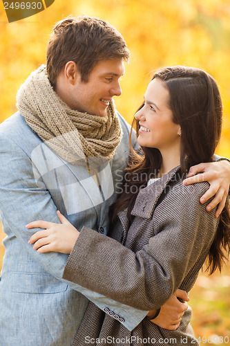Image of romantic couple kissing in the autumn park