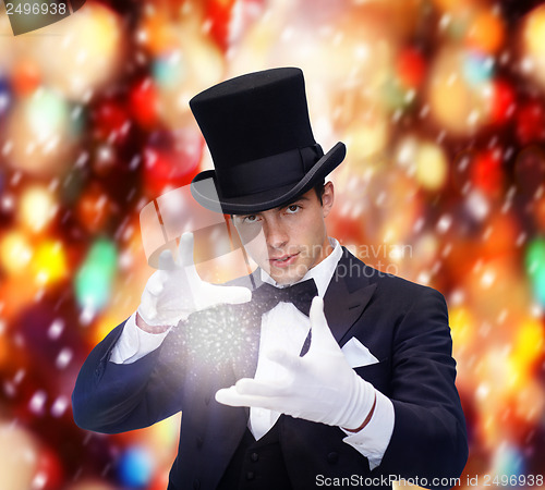 Image of magician in top hat showing trick