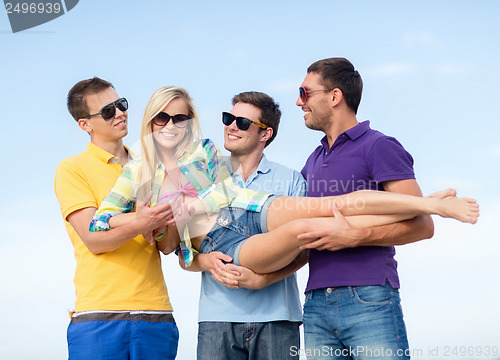 Image of group of friends having fun on the beach