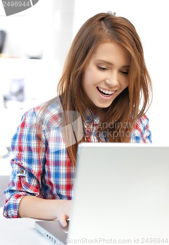 Image of smiling student girl with laptop at school