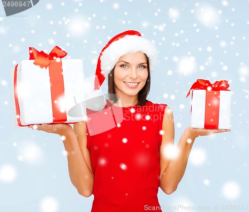 Image of woman in santa helper hat with many gift boxes