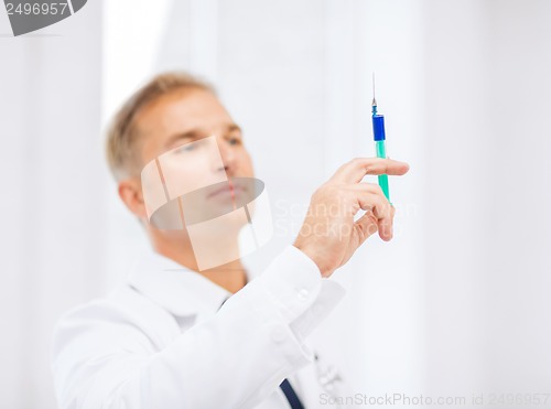 Image of male doctor holding syringe with injection