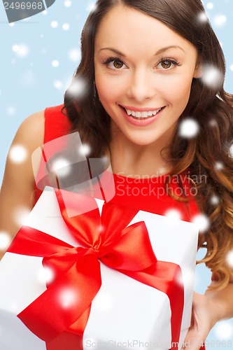 Image of smiling woman in red dress with gift box