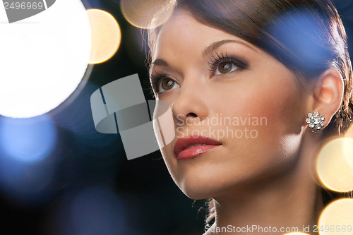 Image of woman in evening dress wearing diamond earrings