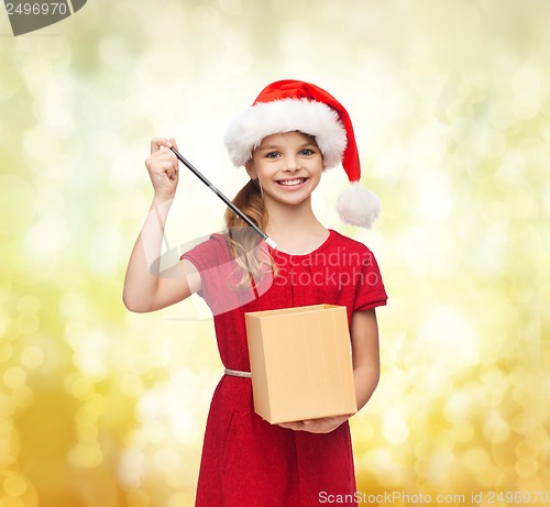 Image of smiling girl in santa helper hat with gift box