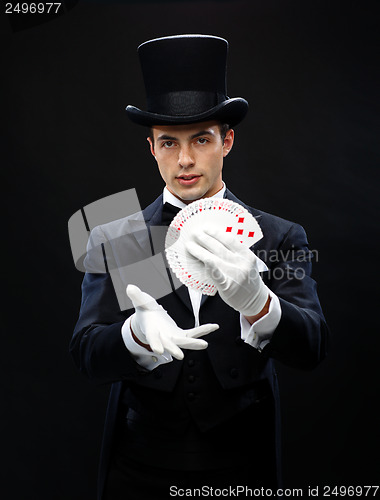 Image of magician showing trick with playing cards