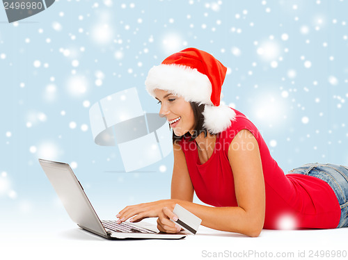 Image of woman in santa hat with laptop and credit card