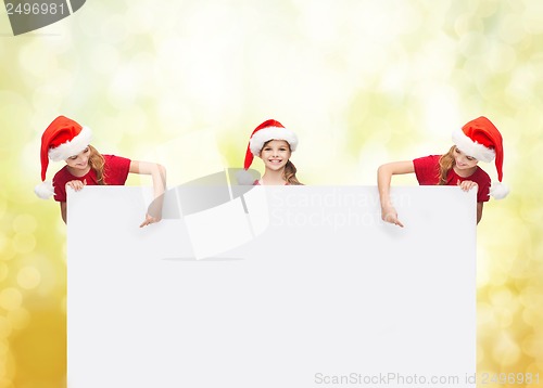 Image of children in santa helper hats with blank board