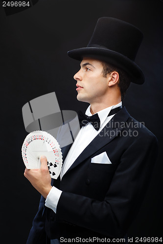 Image of magician showing trick with playing cards