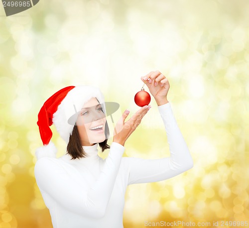 Image of woman in santa helper hat with christmas ball