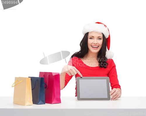 Image of woman in santa helper hat with tablet pc