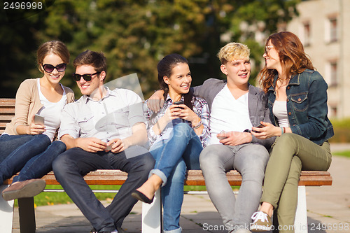 Image of students looking at smartphones and tablet pc