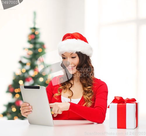 Image of woman with gift box and tablet pc computer