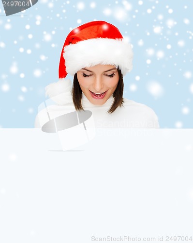 Image of woman in santa helper hat with blank white board