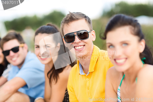 Image of group of friends having fun on the beach