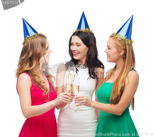 Image of three women wearing hats with champagne glasses