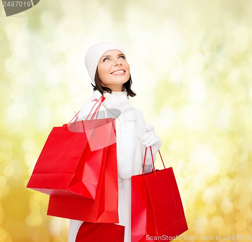 Image of picture of happy woman with shopping bags