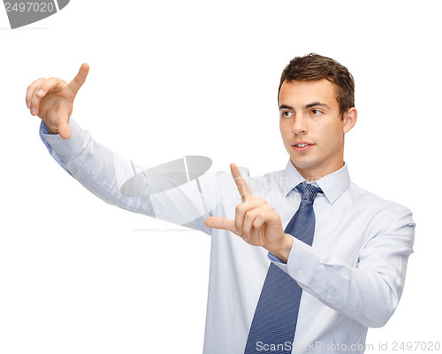 Image of businessman working with imaginary virtual screen