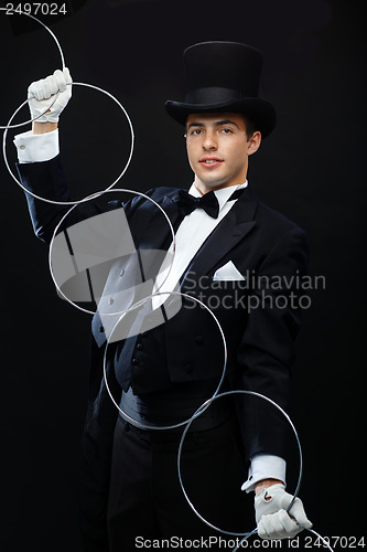 Image of magician showing trick with linking rings