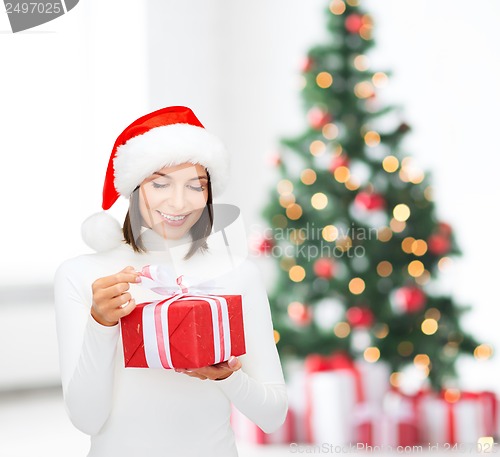 Image of smiling woman in santa helper hat with gift box