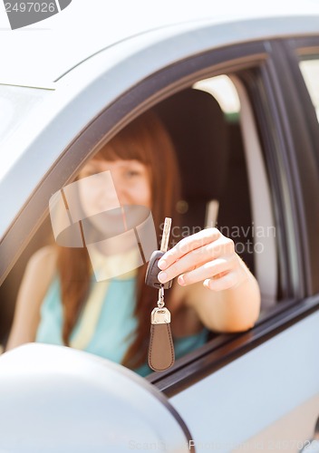 Image of happy woman holding car key