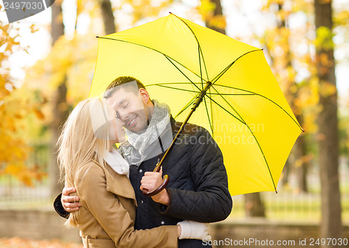 Image of romantic couple kissing in the autumn park