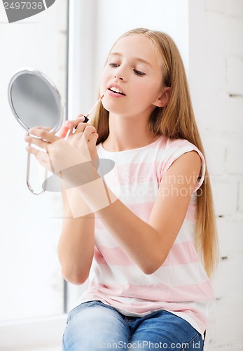 Image of teenage girl with lip gloss and mirror