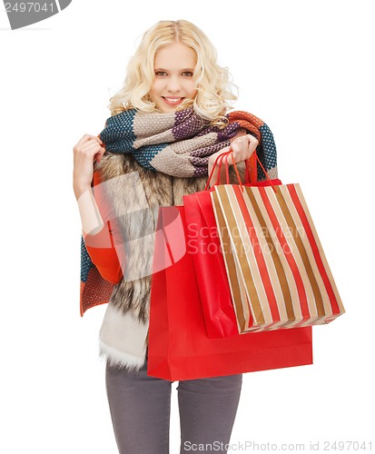 Image of teenage girl in winter clothes with shopping bags
