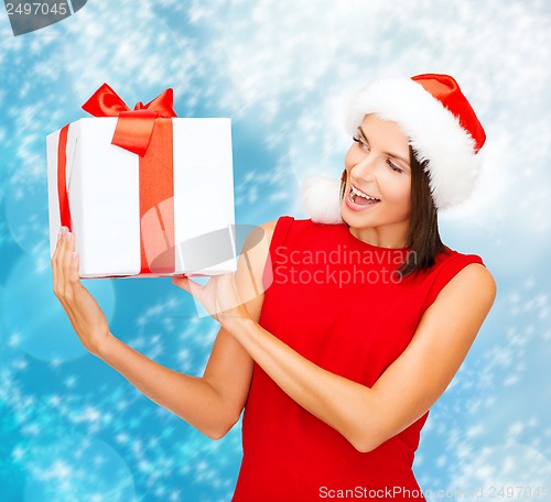 Image of smiling woman in santa helper hat with gift box