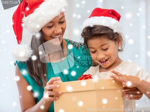 Image of happy mother and child girl with gift box