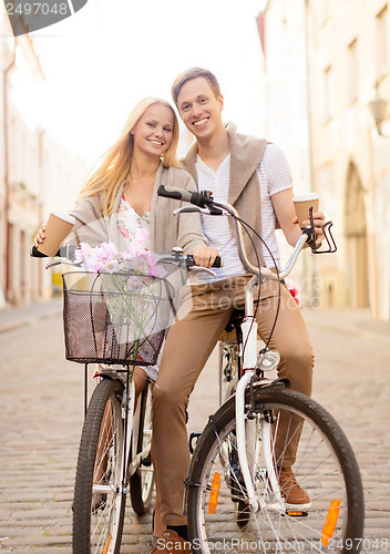 Image of couple with bicycles in the city