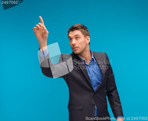 Image of businessman working with imaginary virtual screen