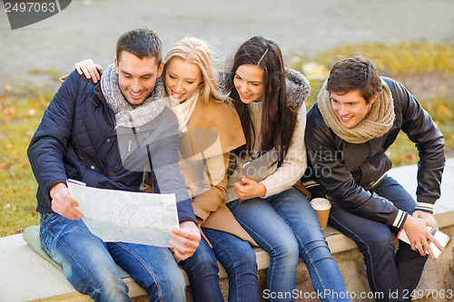 Image of couples with tourist map in autumn park