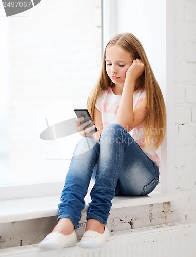 Image of girl with smartphone at school