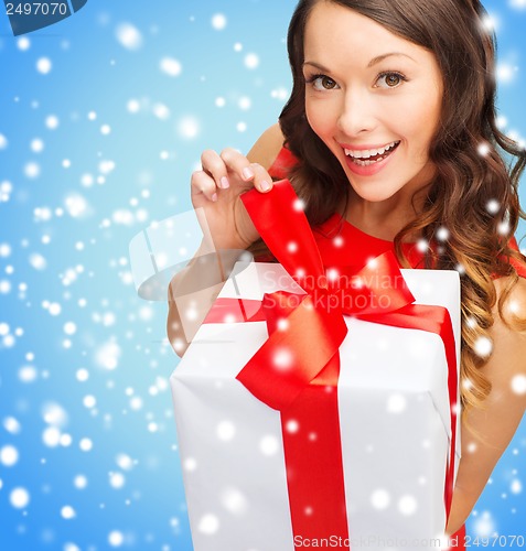 Image of smiling woman in red dress with gift box