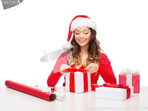 Image of smiling woman in santa helper hat with gift box