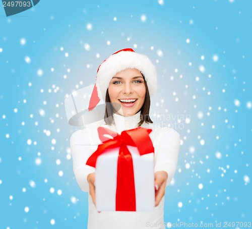Image of smiling woman in santa helper hat with gift box