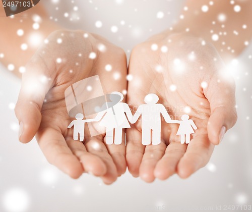 Image of woman hands with paper man family