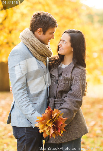 Image of romantic couple kissing in the autumn park